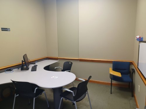 study room with table, chairs and whiteboard