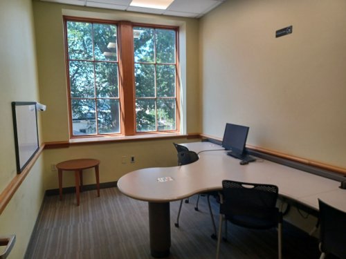 study room with table, chairs and whiteboard