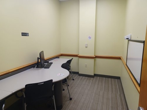 study room with table, chairs and whiteboard