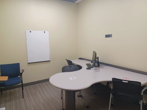 study room with table, chairs and whiteboard