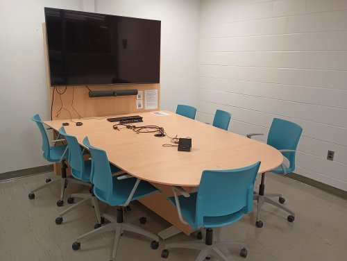 study space with conference table, and monitor