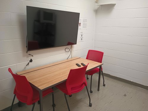 Viewing room with desk, chairs, and a monitor