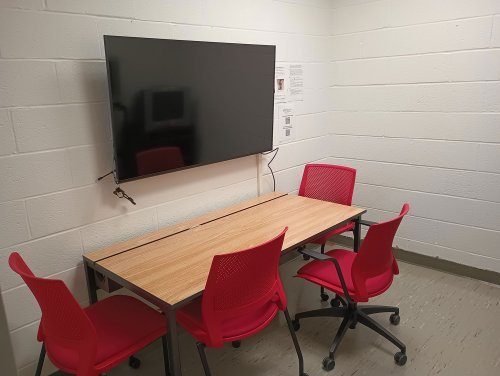 Viewing room with desk, chairs, and a monitor