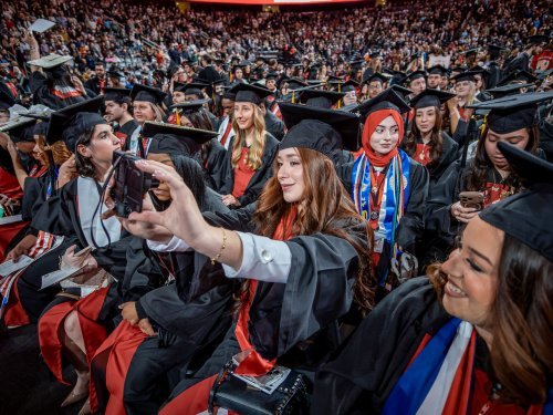 a crowd of graduating students in modern day
