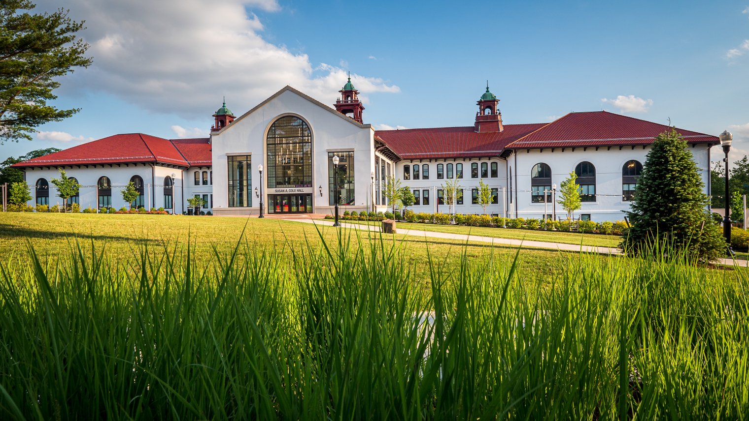 A picture of Cole Hall with grass in the foreground and sky in the background.