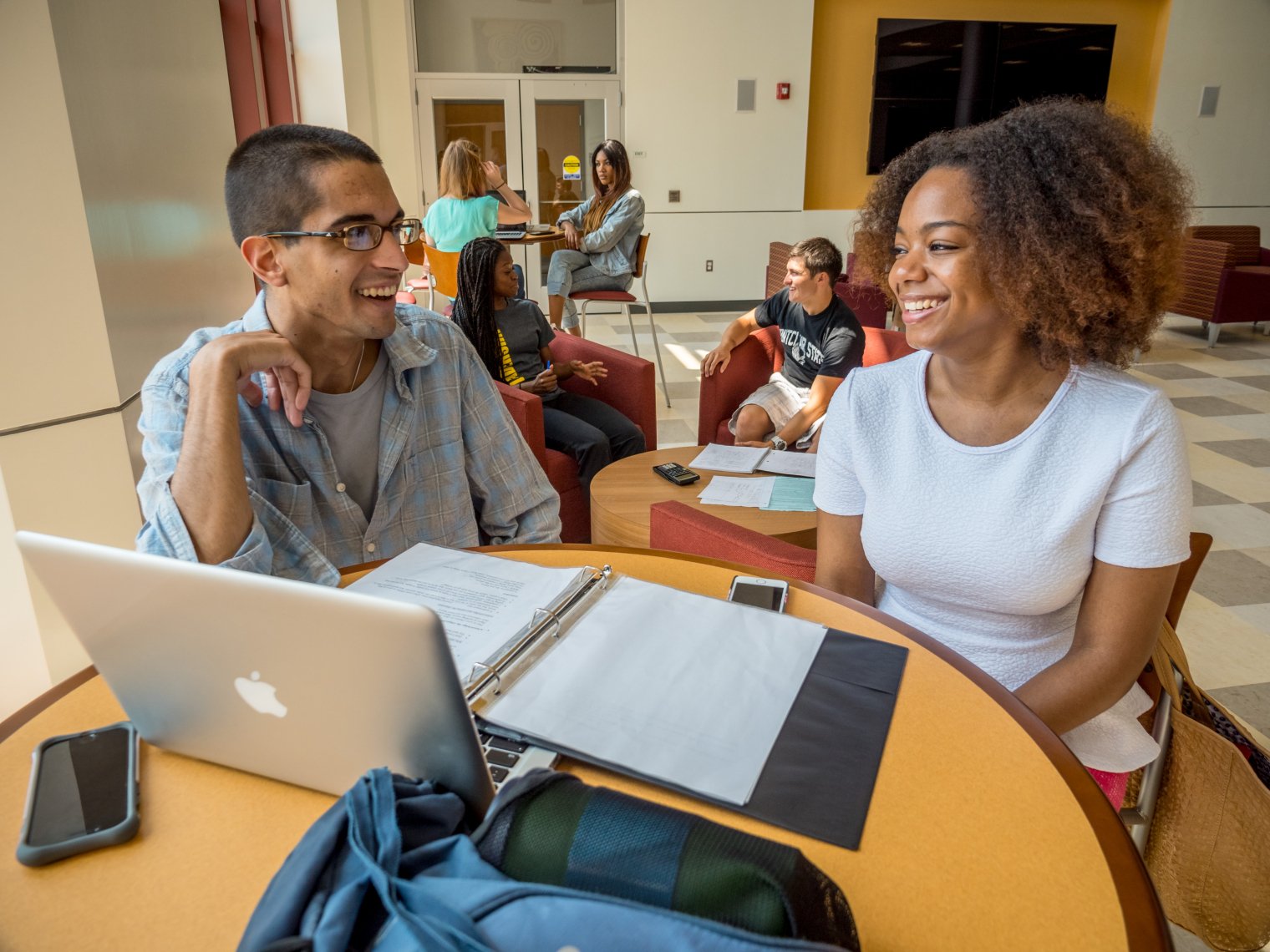 Two students sitting at a table studying.