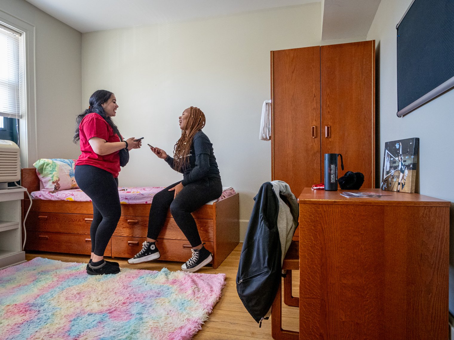 two students in a residence hall room talking