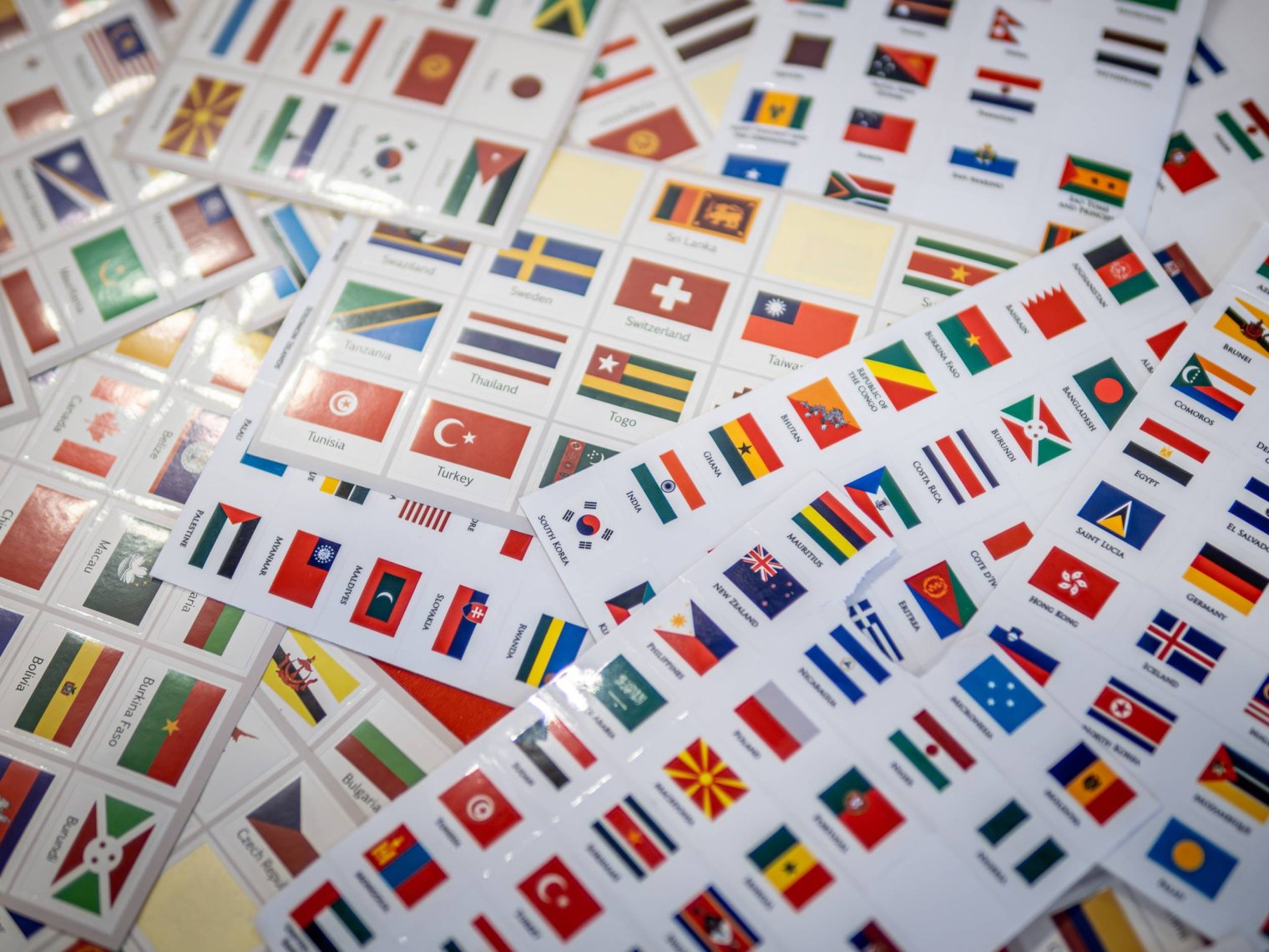 A pile of stickers of various country flags