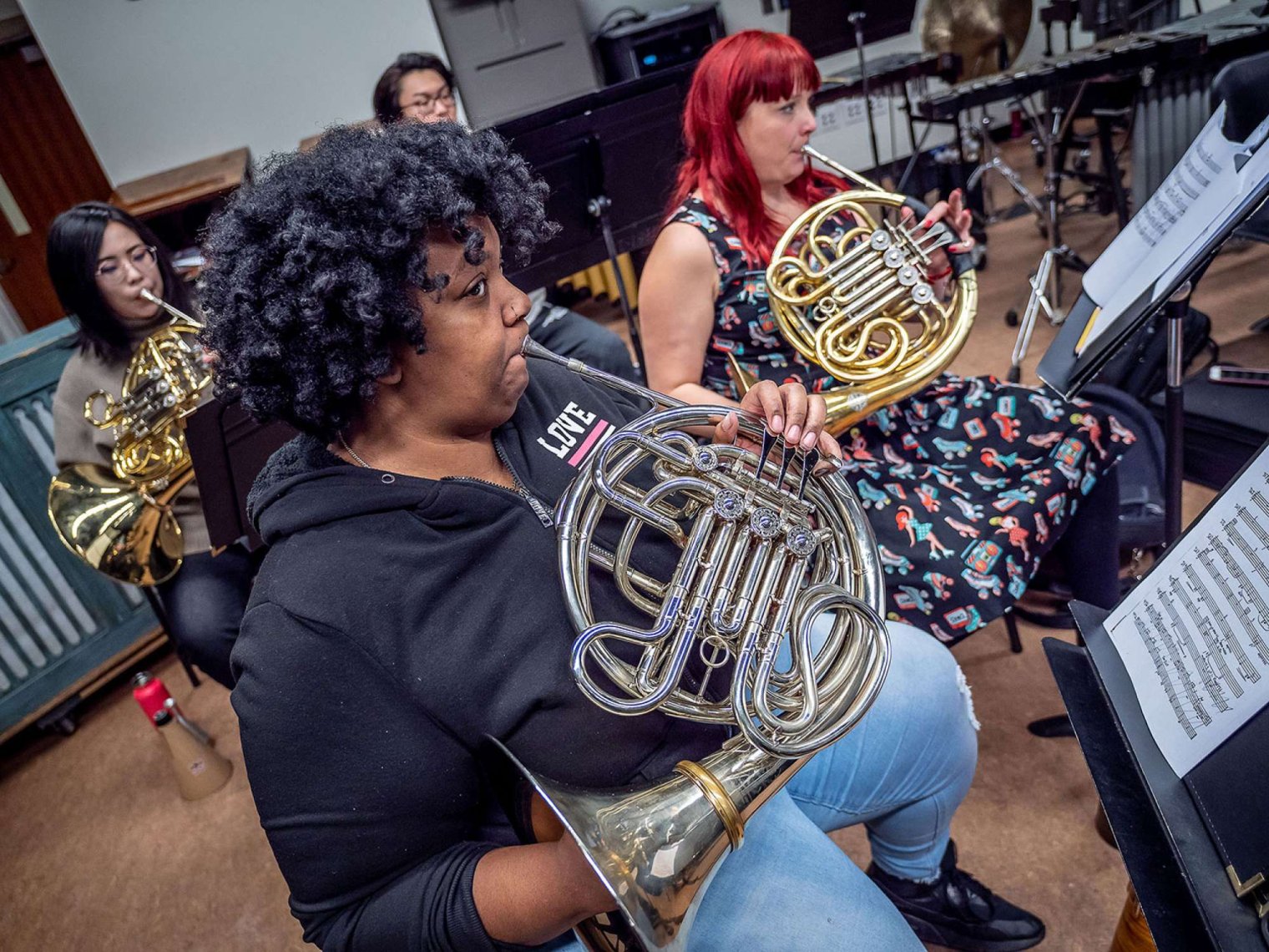 Cali School of Music students on their French horns during a rehearsal. (Photo by University Photographer Mike Peters.)