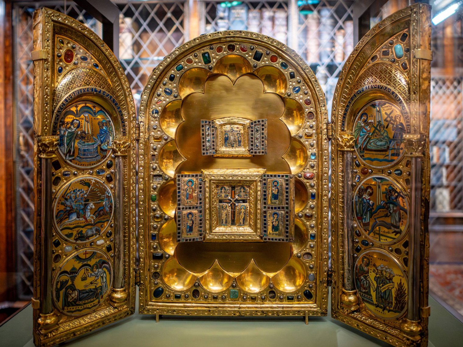 An open golden triptych decorated with Christian religious motifs