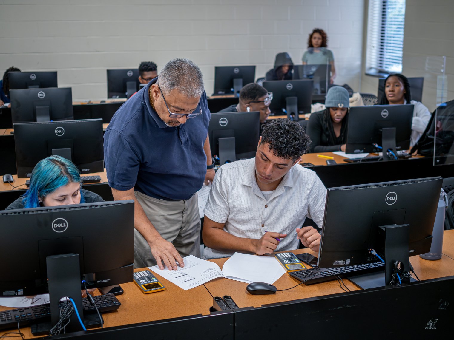 Instructor and students in a computer lab
