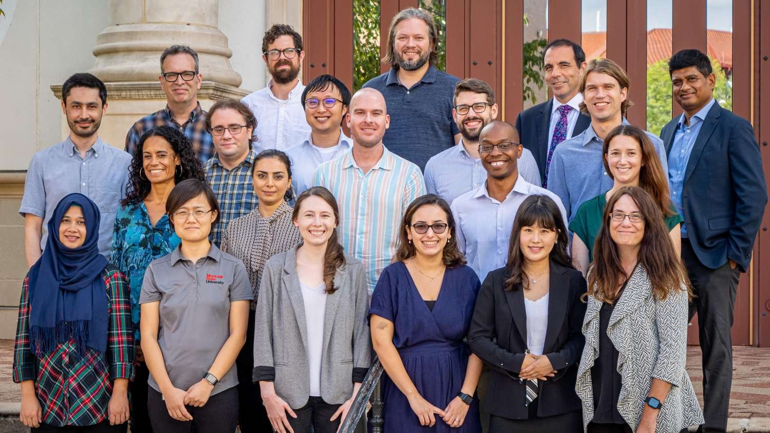 New faculty at Montclair stand in front of University Hall