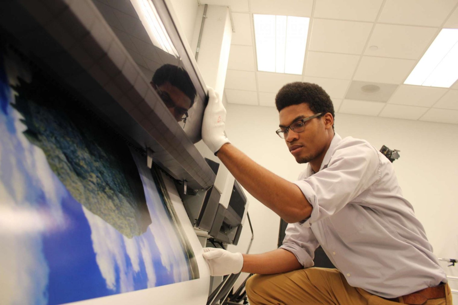 Student printing artwork in the Creative Print Center