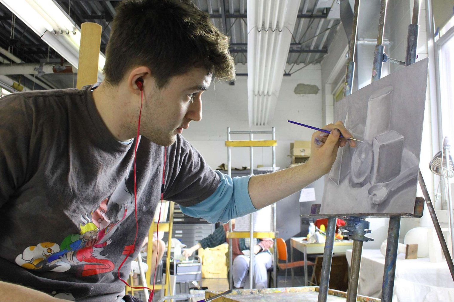 Student painting on a canvas in the Painting Studio