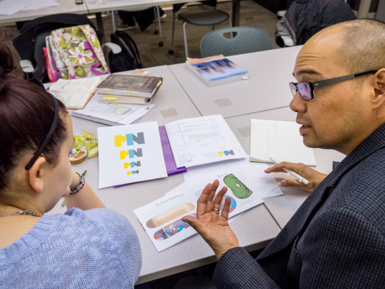 Visual Communication Design classroom with student speaking with professor