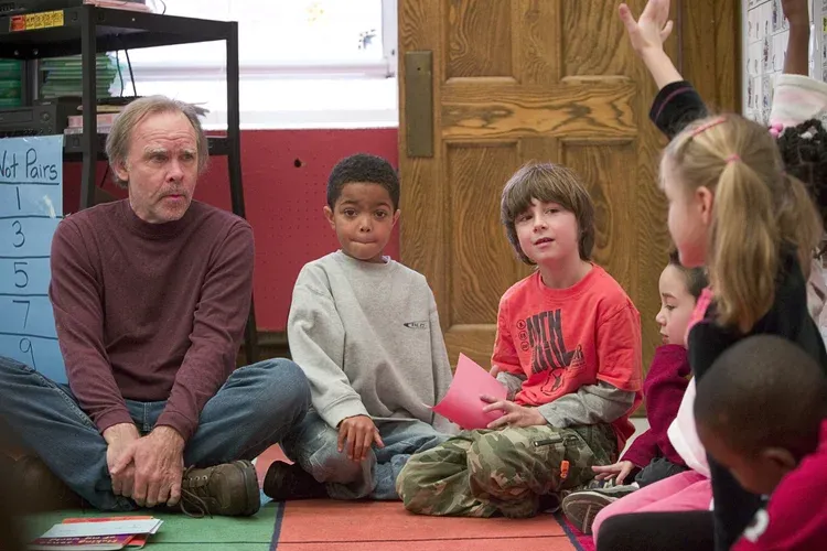 Teacher sitting in circle with students