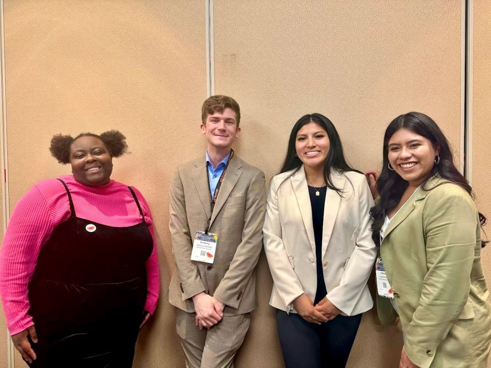Four Students posing together at conference