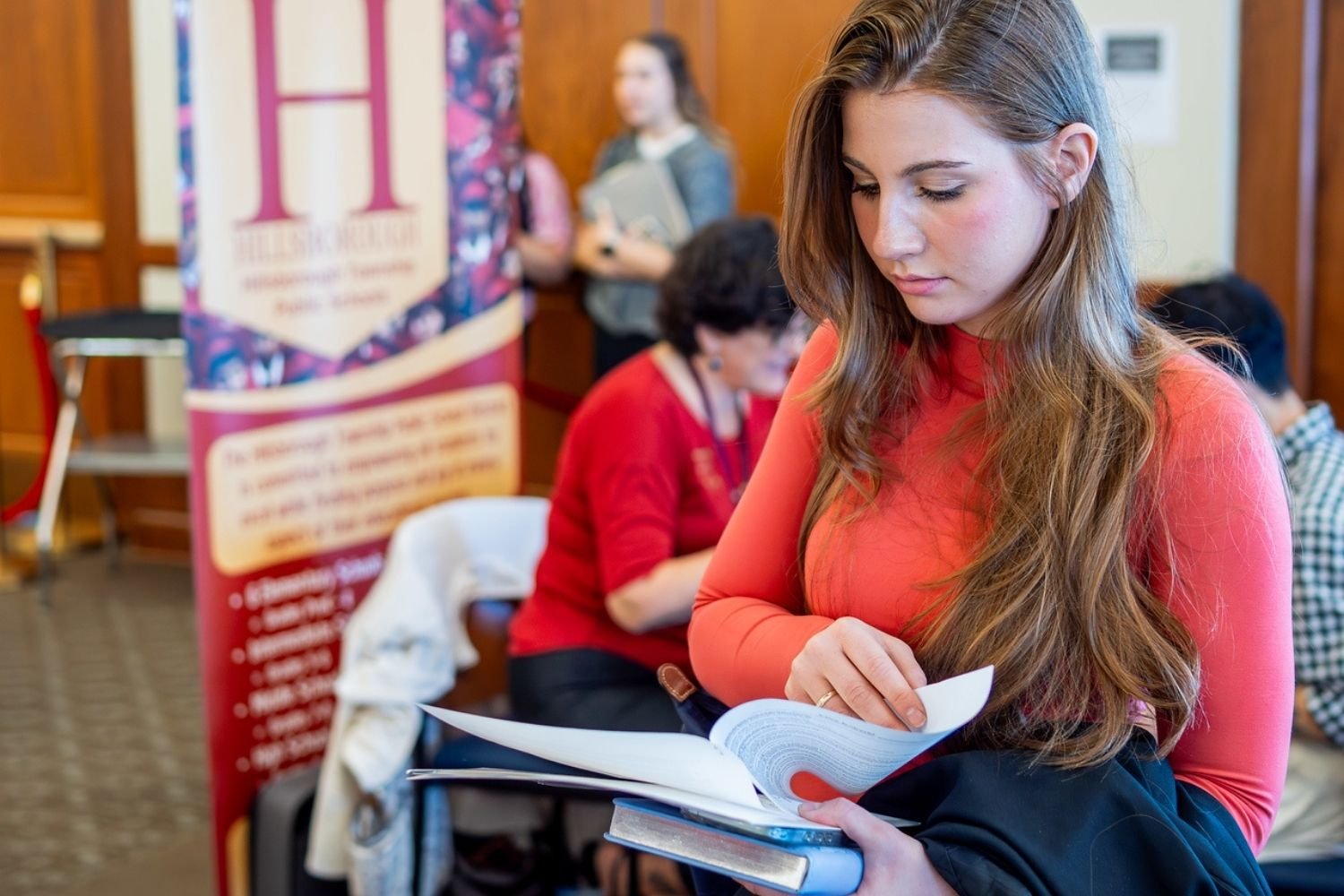 Student reviews her resume at a job fair.