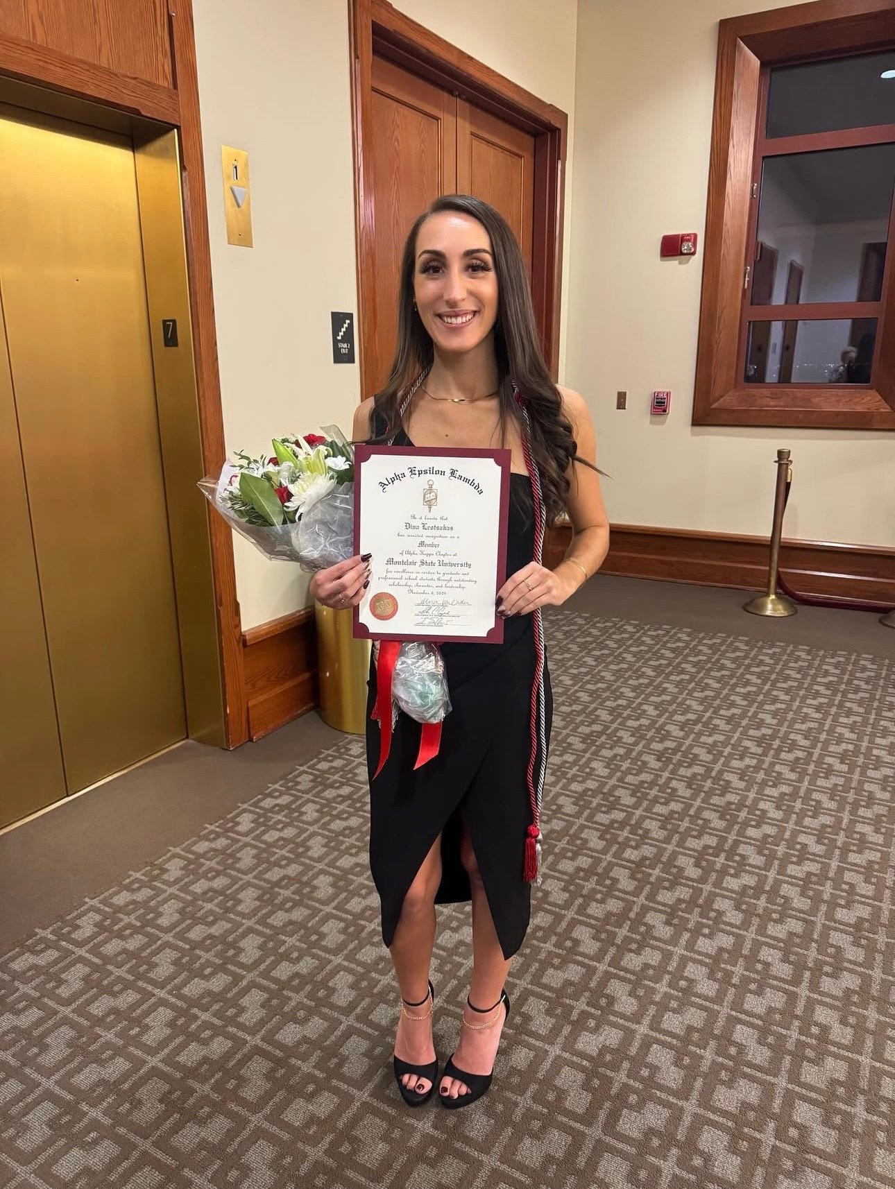 Dina celebrates her induction into Alpha Epsilon Lambda, Montclair’s graduate honor society.