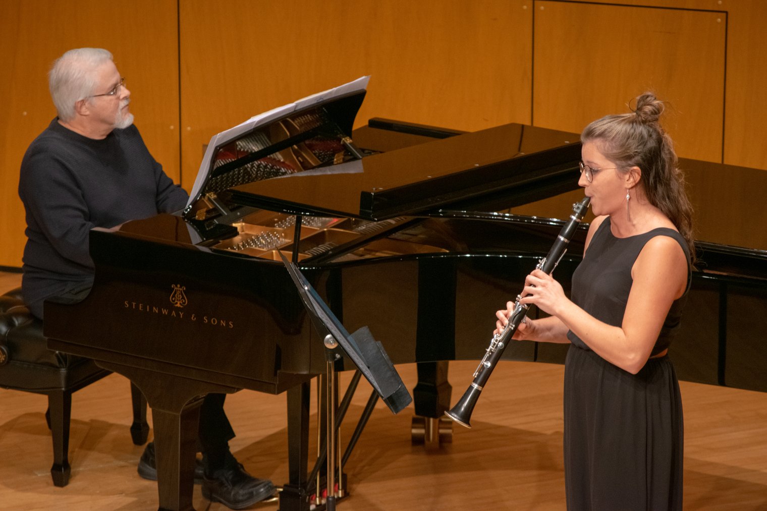 Oboe performing with piano accompanist on stage