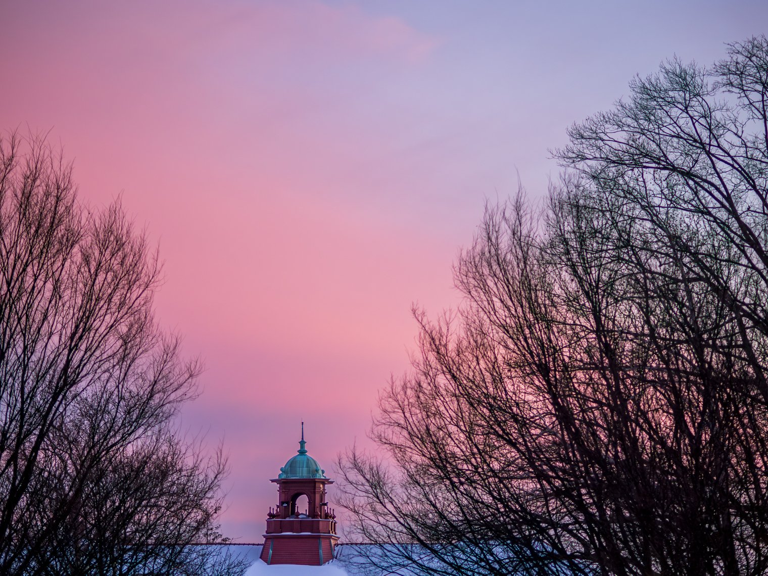 Cole Hall bell tower at sunset on wintry night