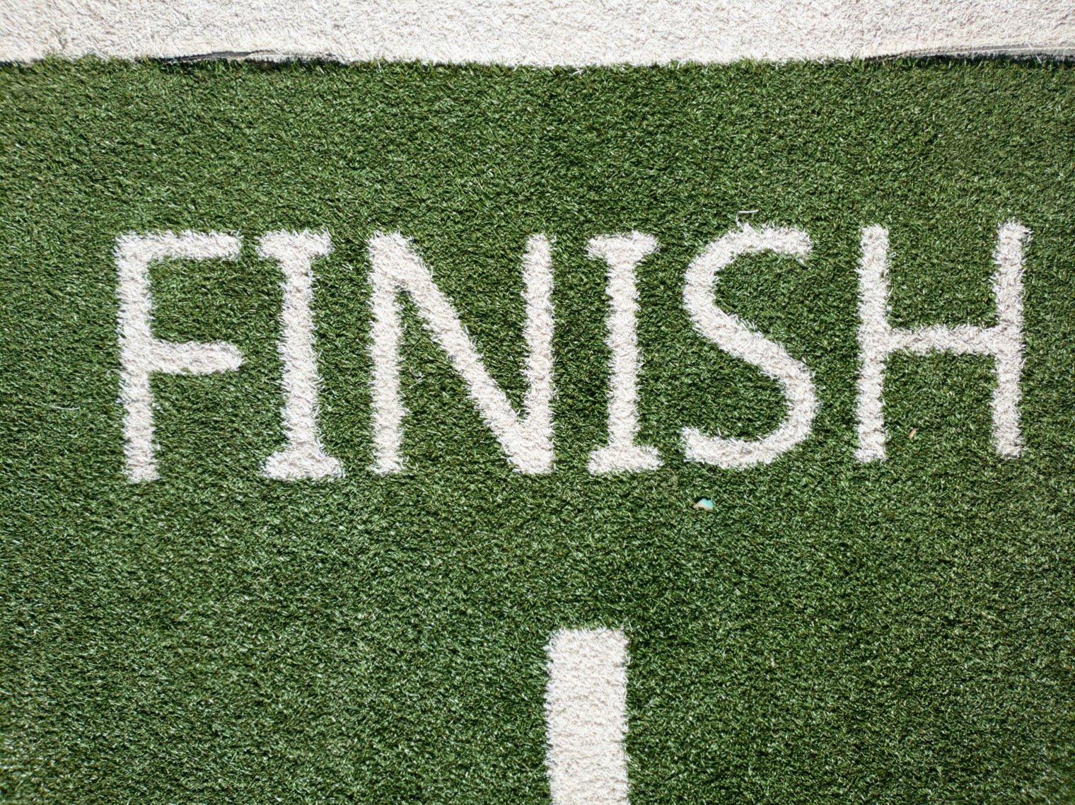 "FINISH" in white letters on artificial turf