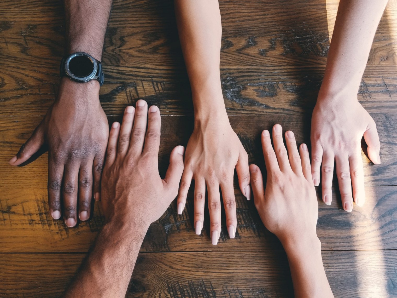 five hands of varying skin tones 