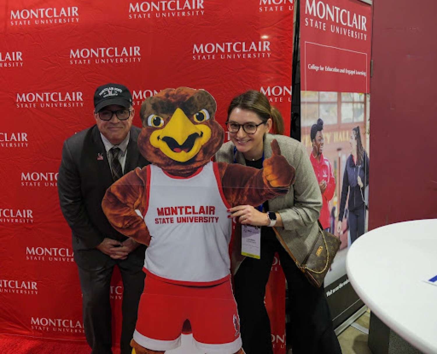 Dean Vincent C. Alfonso and Lauren Conforti of the College for Education and Engaged Learning pose with Rocky the Red Hawk.