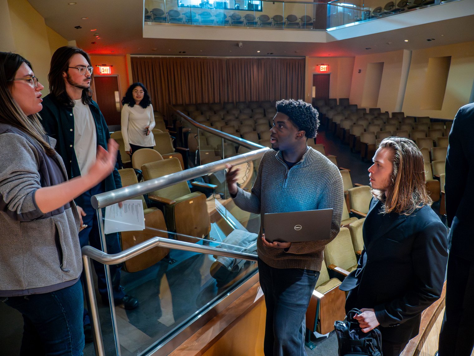 Isaac Afriyie-Addo consults with other students at rehearsal.
