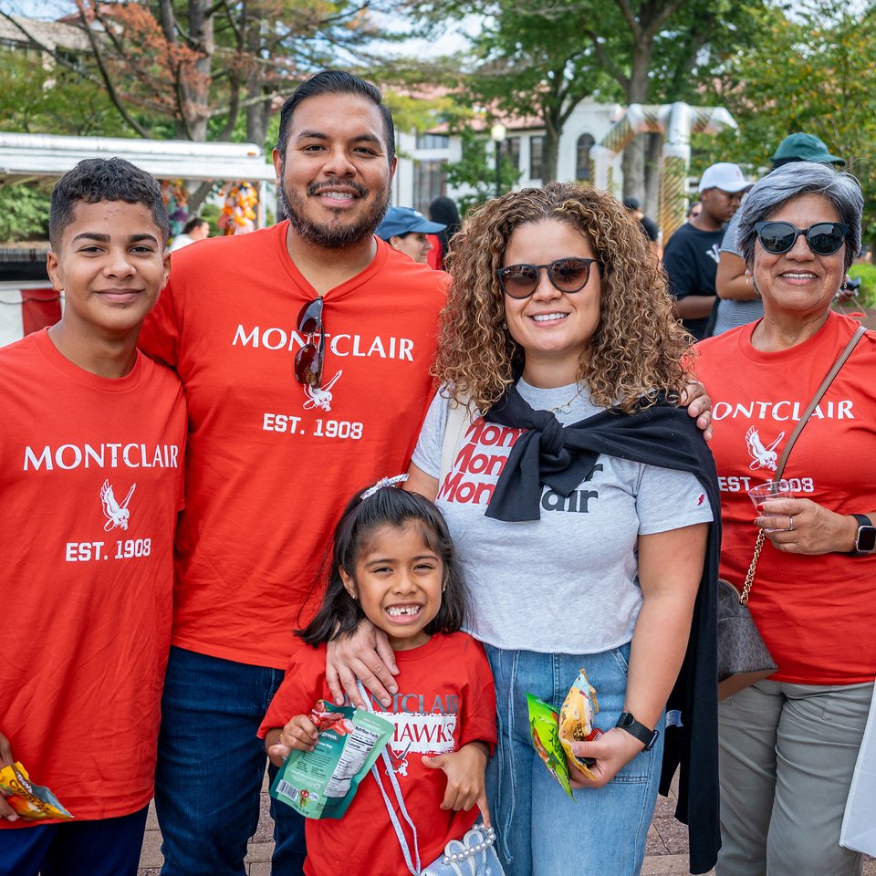 Three adults and two kids in Montclair shirts smiling for a photo