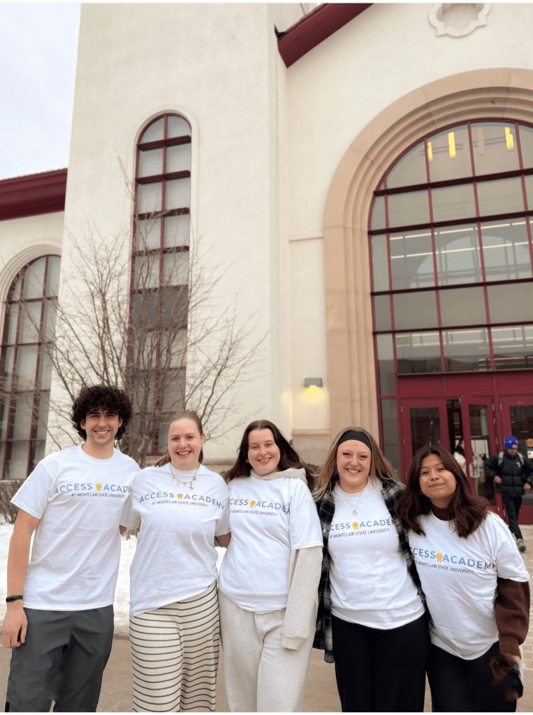 Group of students posing in their Access Academy t-shirts.