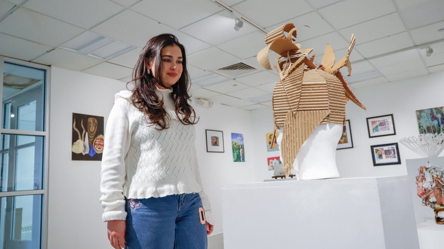 Student looking at artwork in the Finley Gallery