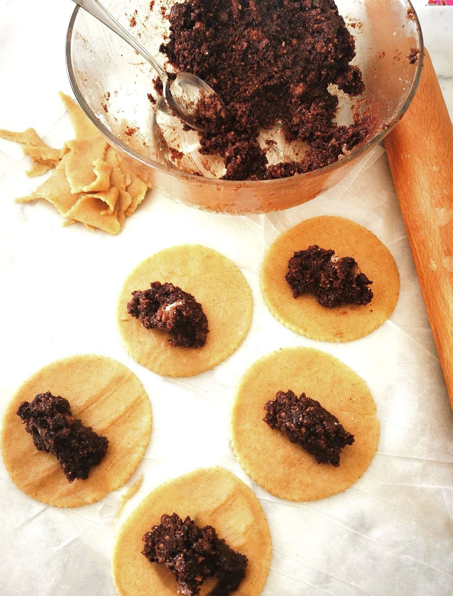 mpanatigghi filling being places on pastry disks