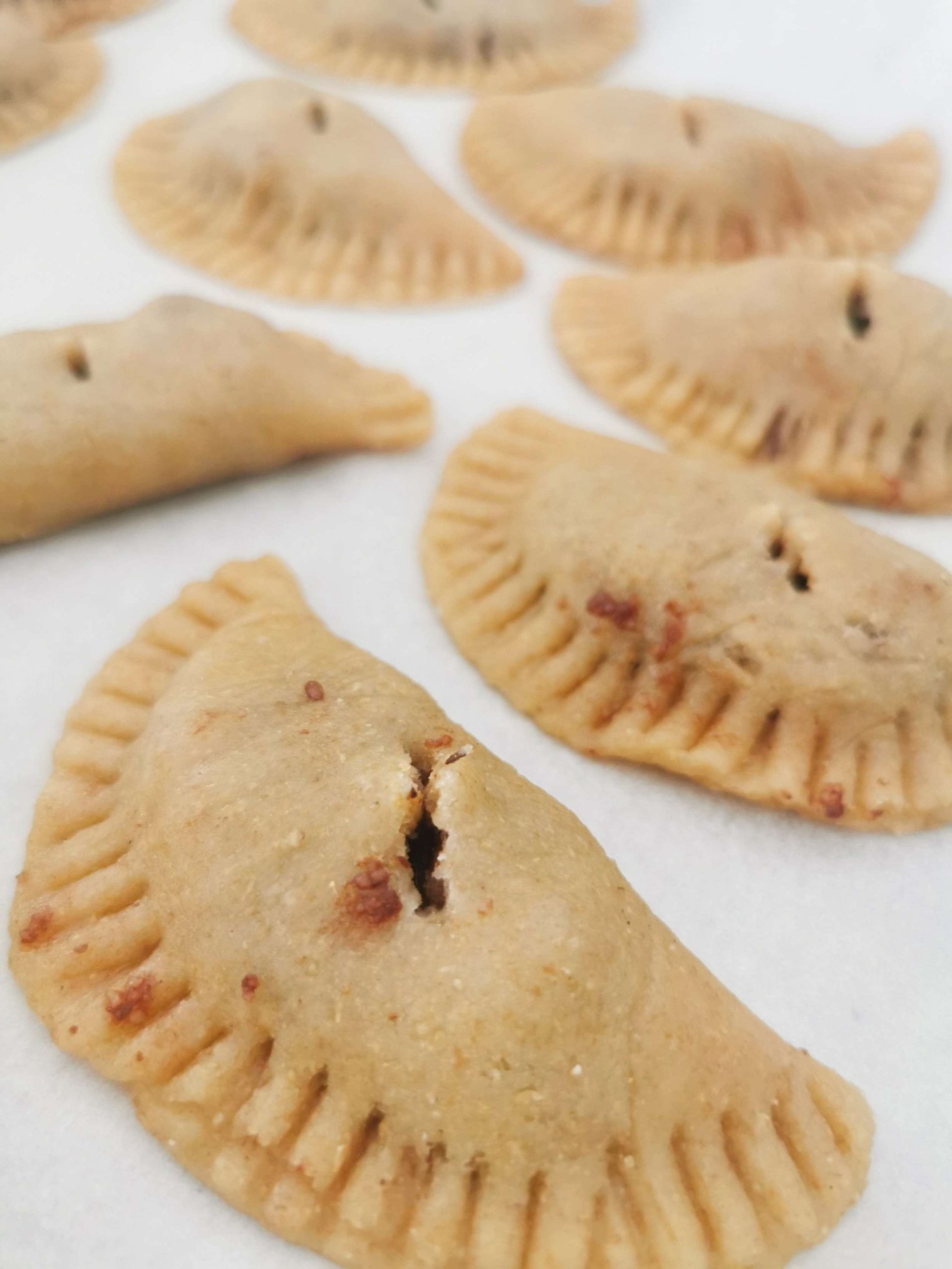 mpanatigghi on a table ready to go into oven