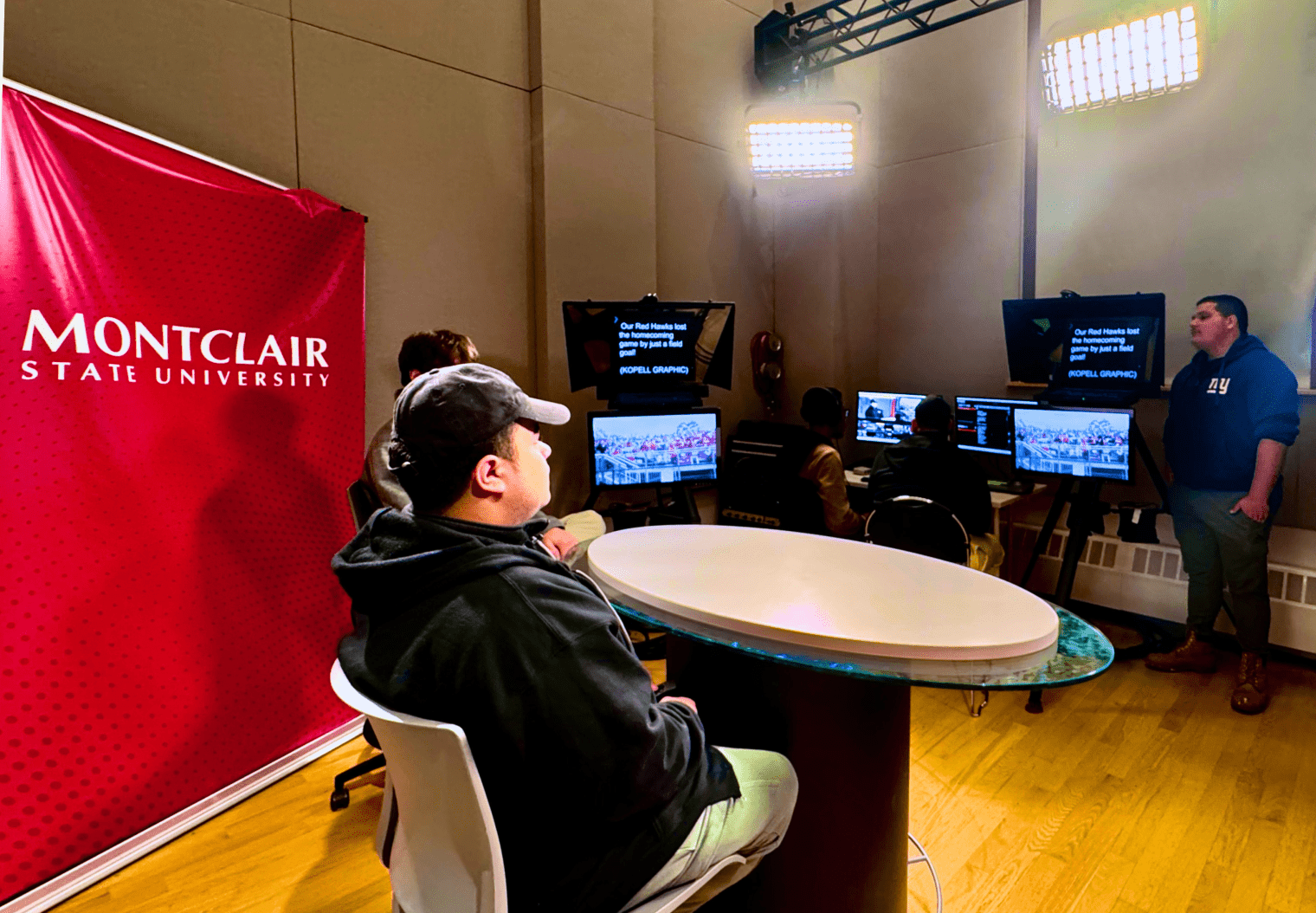 Students sitting at desk at the digital lab studio.