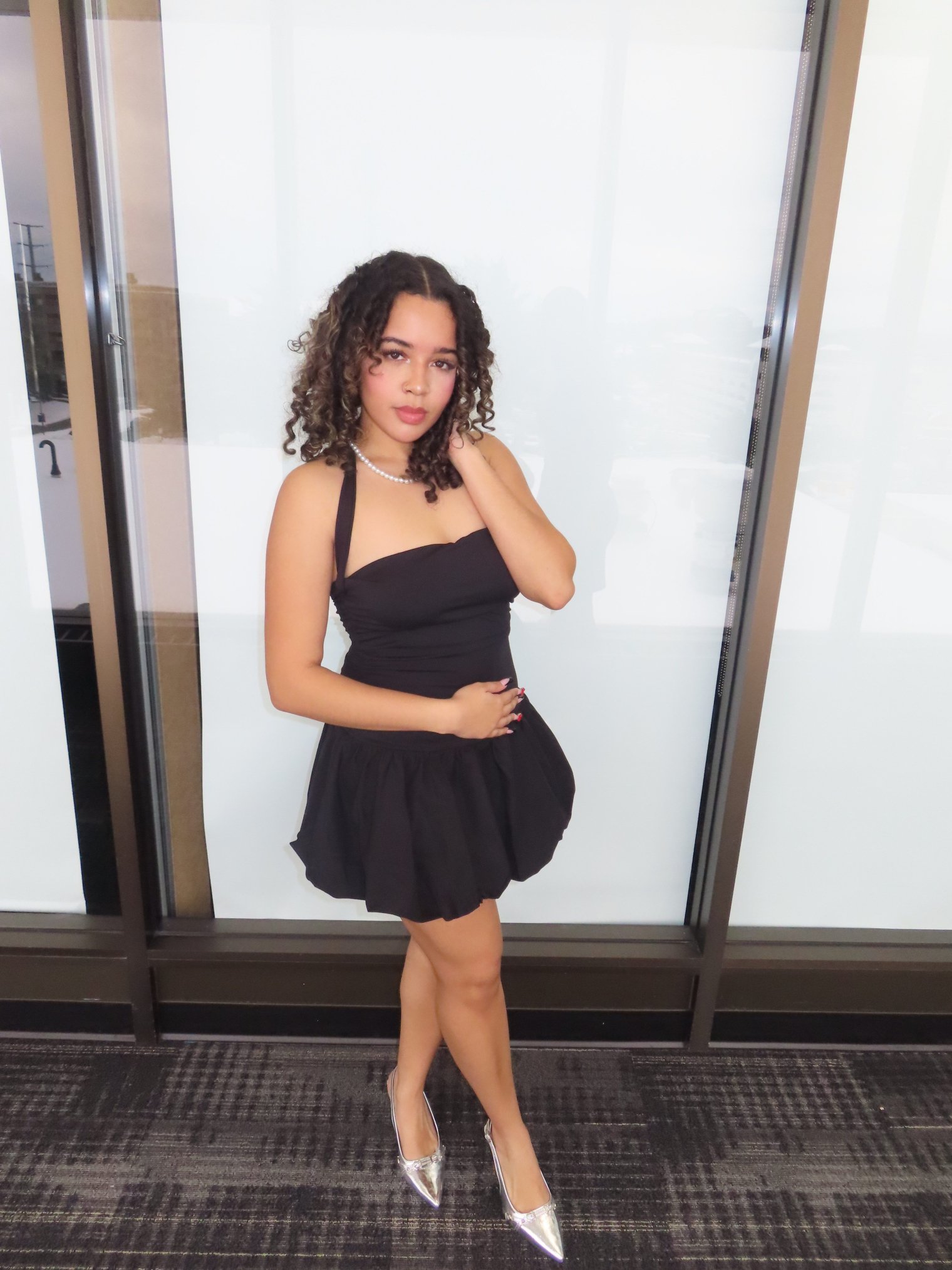 Tahina poses in formal attire at a campus event.