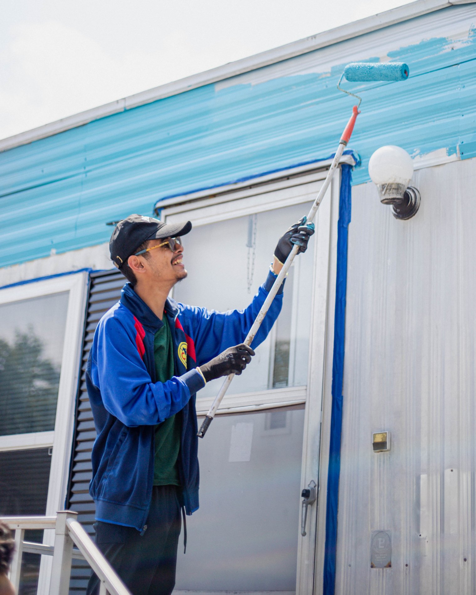 Photo of Jose Juarez painting a trailer during bonner orientation 