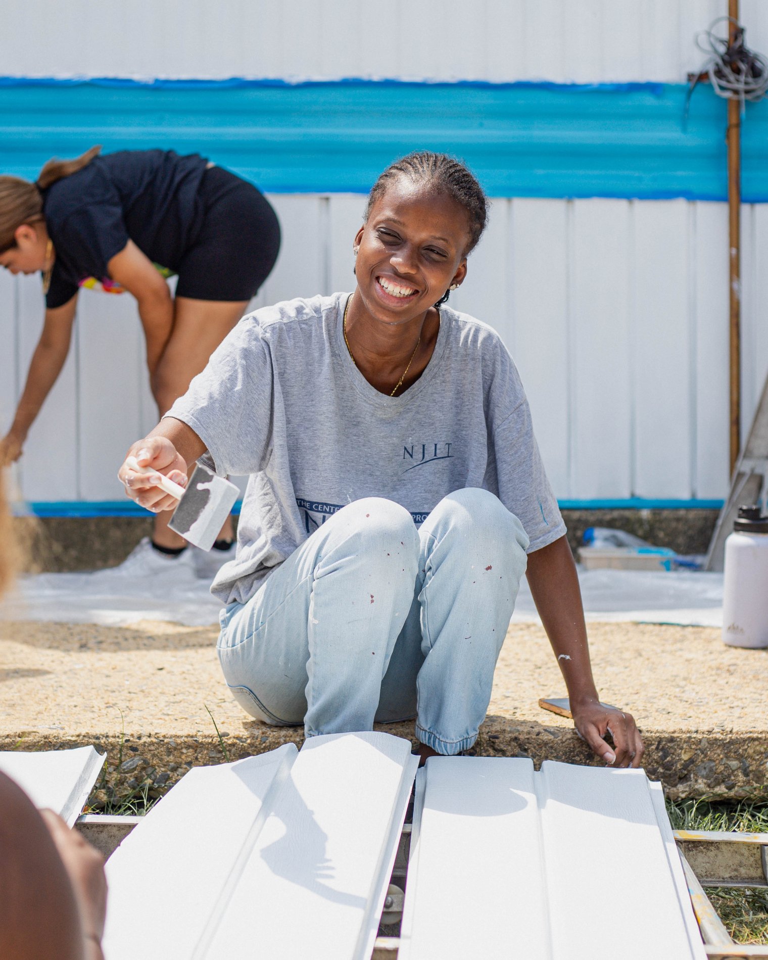 Photo of Aissa Diallo painting during Bonner Orientation