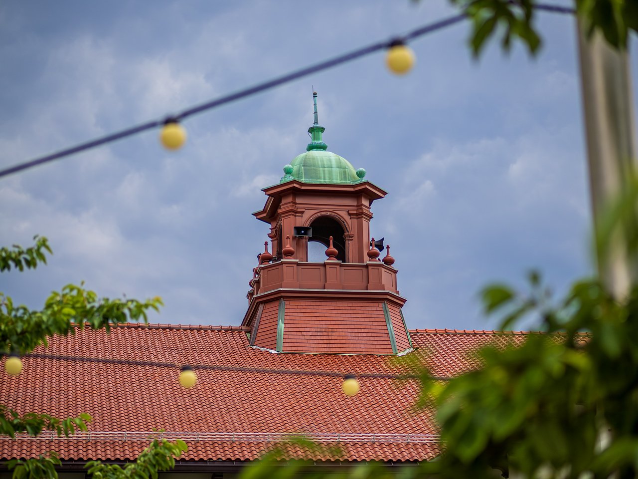 Bell tower with string lights in frame 