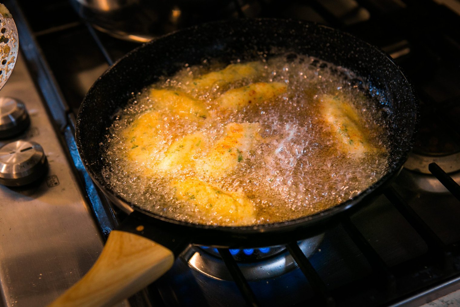 A close up of pastries being cooked in a cast iron skillet
