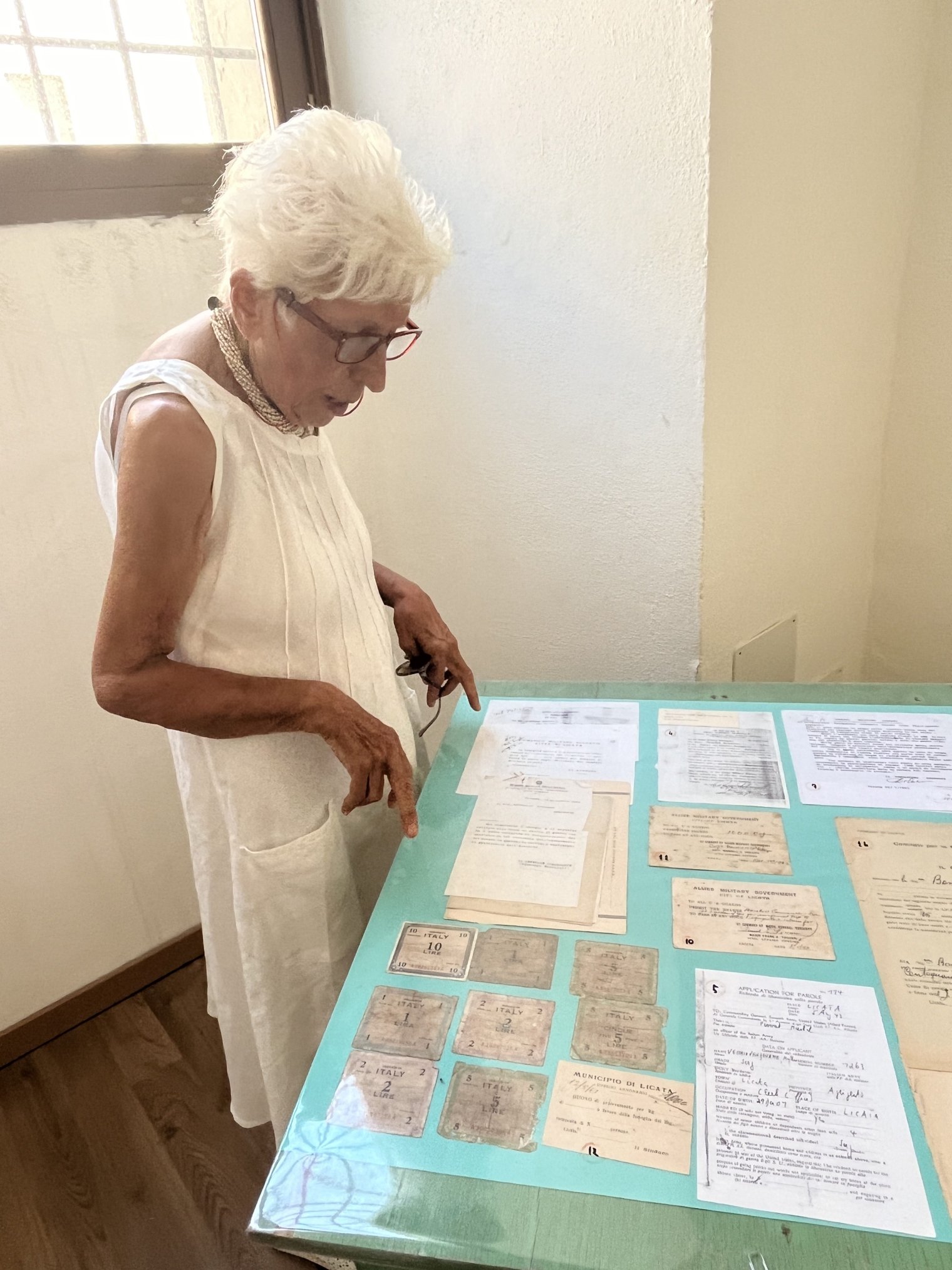 An older woman studies a display in a musem