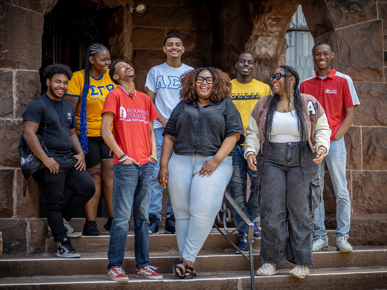 A group of people standing on stairs laughing