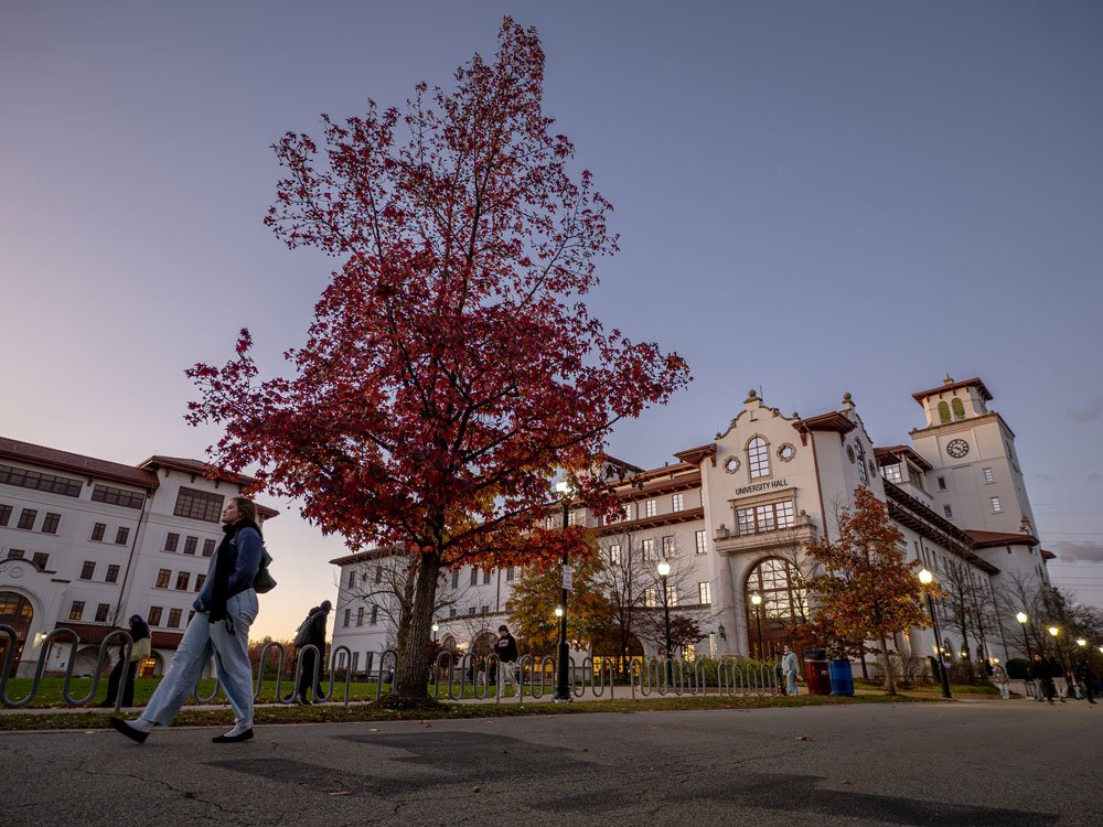 university hall with people walking at dusk