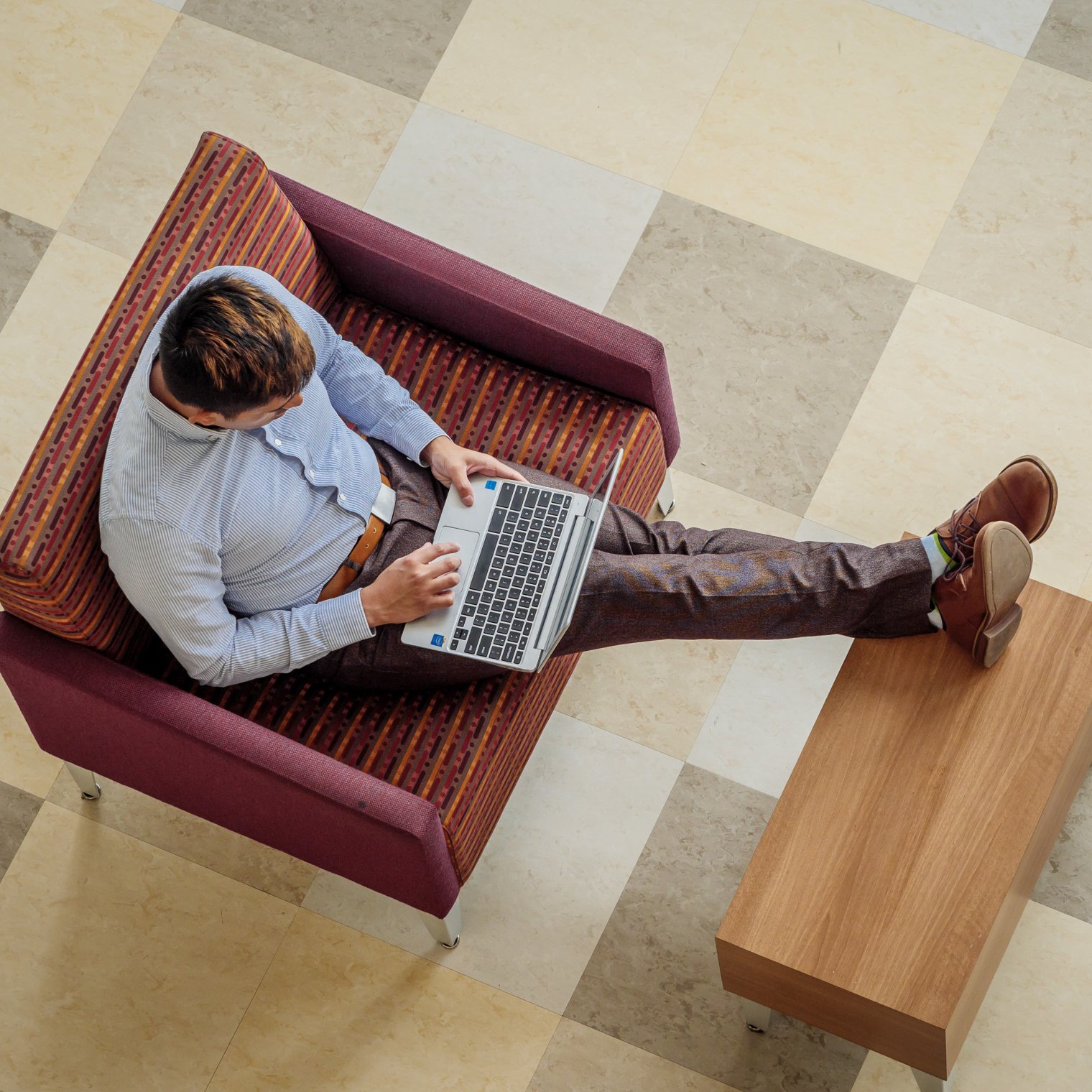 Overhead view of a man working on his laptop.