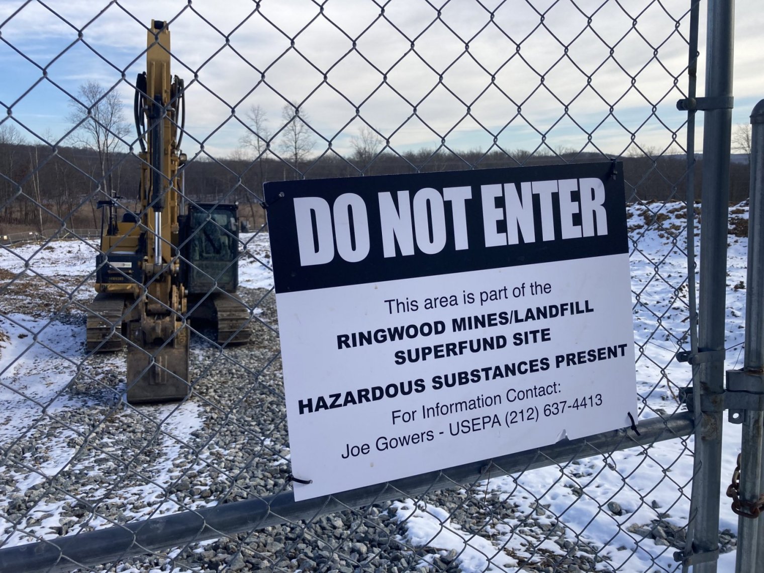 A sign reading "Do Not Enter" is posted on a chain-link fence
