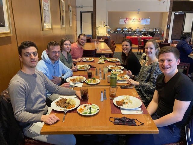 exchange program students in at table in dining hall