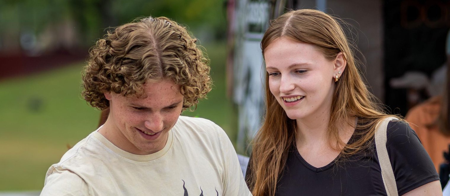 Students attend an outdoor event on campus.