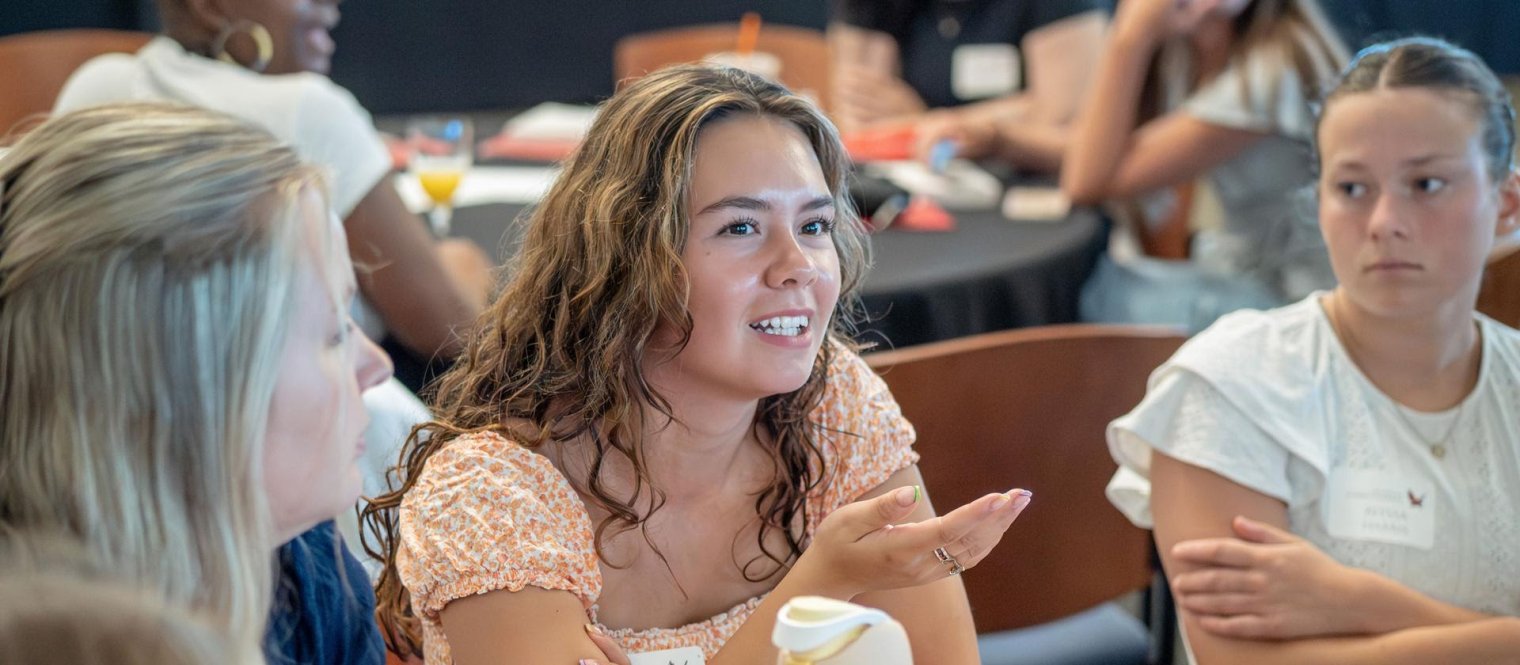 Students chat at a campus event.