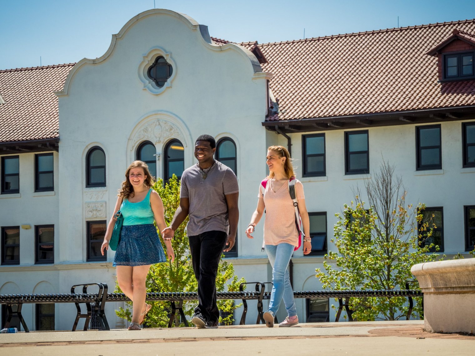 students smiling and walking on campus