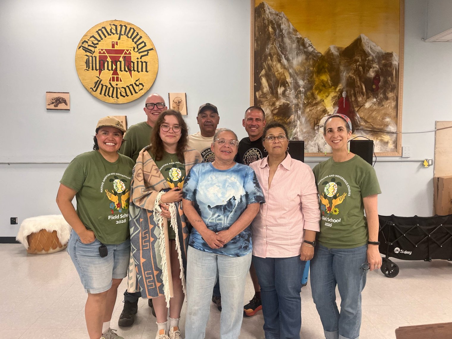 A group of NAIS Field School Team members stand with Partners at a closing event at the Ramapaough Community Center